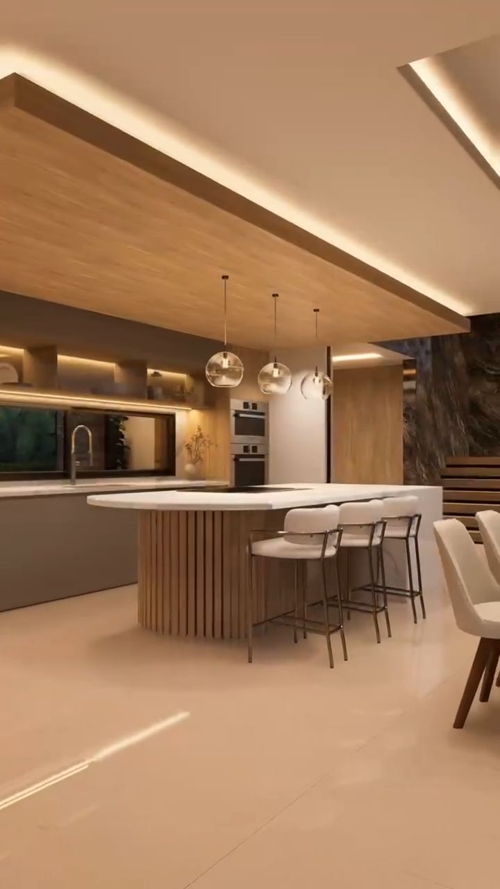 Cocina con isla curva y cielorraso de madera iluminado